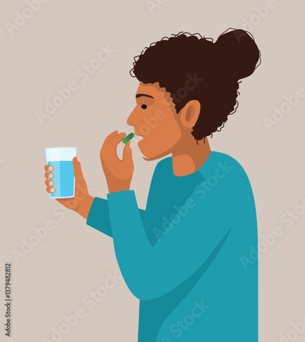 Sick African woman taking medicine capsule with a glass of water