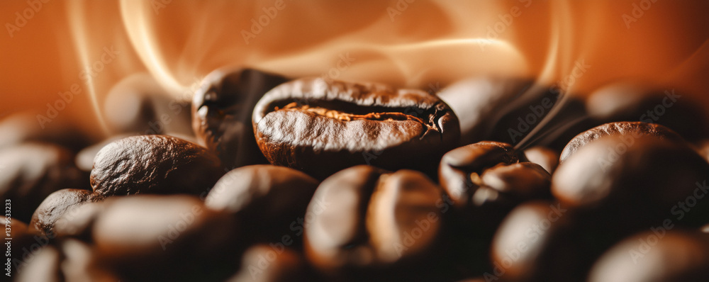 Close-up of coffee beans with smoke rising from them.