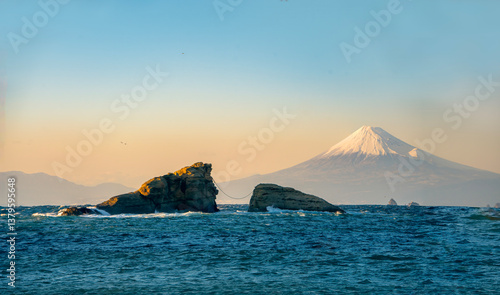 Mount Fuji Sunset View with Sacred Wedded Rocks at Kumoni Shore, Izu Peninsula, Japan. A breathtaking sunset view from Kumoni Shore on the Izu Peninsula, Japan.


