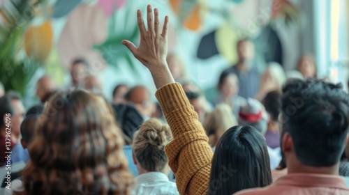 Active participation in conference raising hand with diverse crowd of attendees