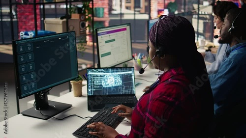 Call center employee using AI chatbot at office desk to reply to common customer queries, close up. Customer service staff member at work generates automated responses to clients using AI, camera B