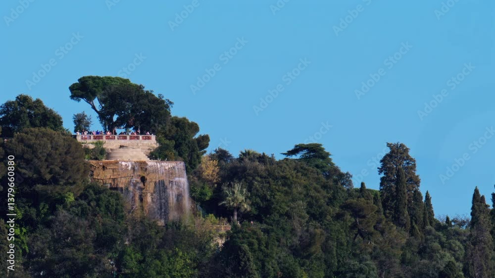 Distant view of the Cascade du Chateau on the Chateau hill in daylight, Nice, France Distant view of the Cascade du Chateau on the Chateau hill in daylight, Nice, France