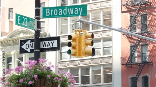 Broadway street road sign, Manhattan midtown architecture, New York City corner. Yellow traffic light. Flatiron district near Madison Square Park. Crossroad of 23 st., Bway and 5 Fifth avenue. One way