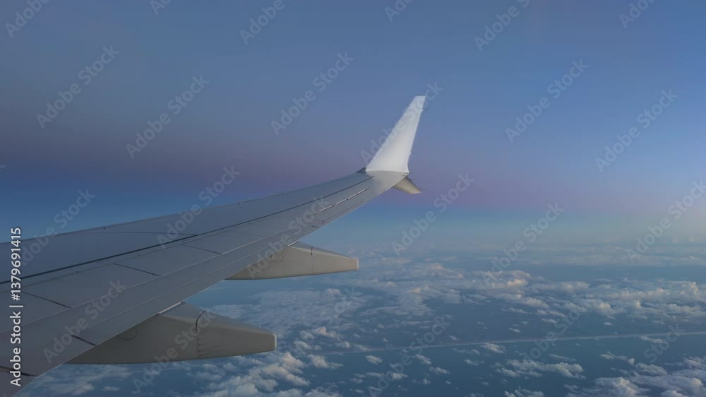 Sunset view through airplane window over the ocean and coast Sunset view through airplane window over the ocean and coast
