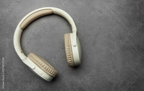 Wireless headphones resting on gray surface