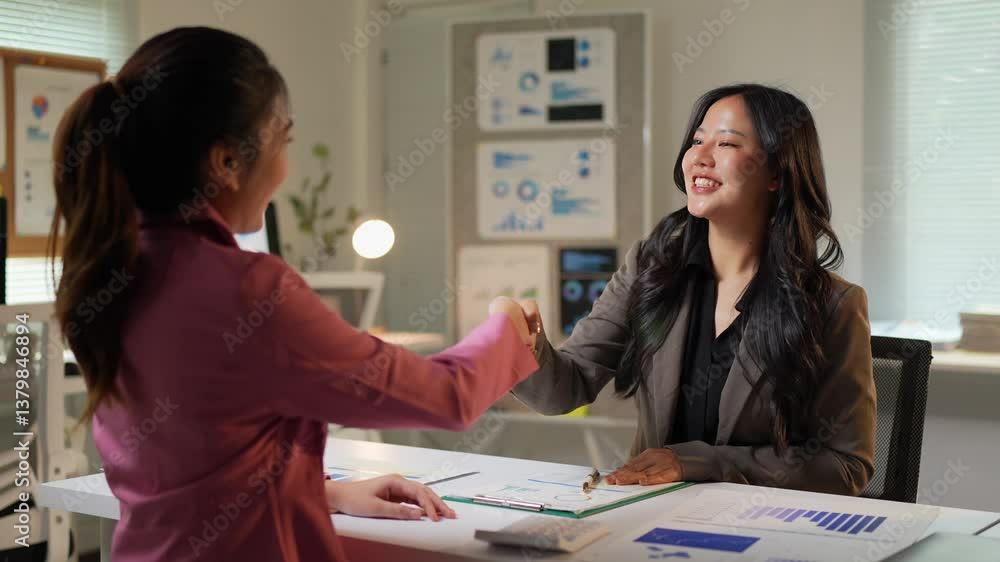 Professional asian businesswomen sealing successful partnership, shaking hands in modern office setting, celebrating collaborative business agreement with confident, positive engagement Professional asian businesswomen sealing successful partnership, shaking hands in modern office setting, celebrating collaborative business agreement with confident, positive engagement