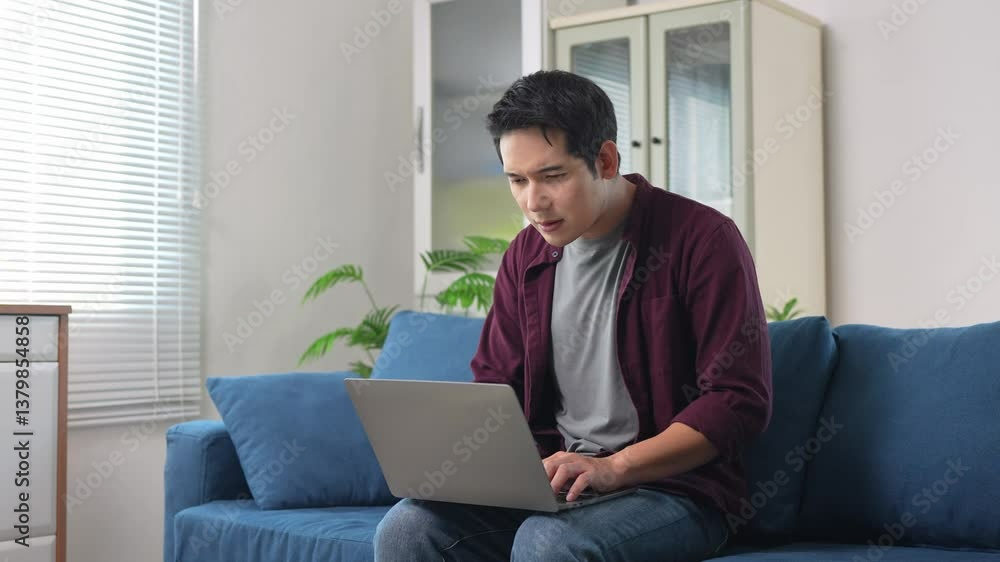 Asian freelancer experiencing eye strain while working from home Asian freelancer experiencing eye strain while working from home