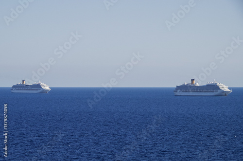 Obraz na płótnie Mega family cruiseship cruise ship liners Favolosa and Fortuna anchored offshore of Civitavecchia Rome, Italy before reactived after Covid pandemic with other vessels in port and coastline w salonie