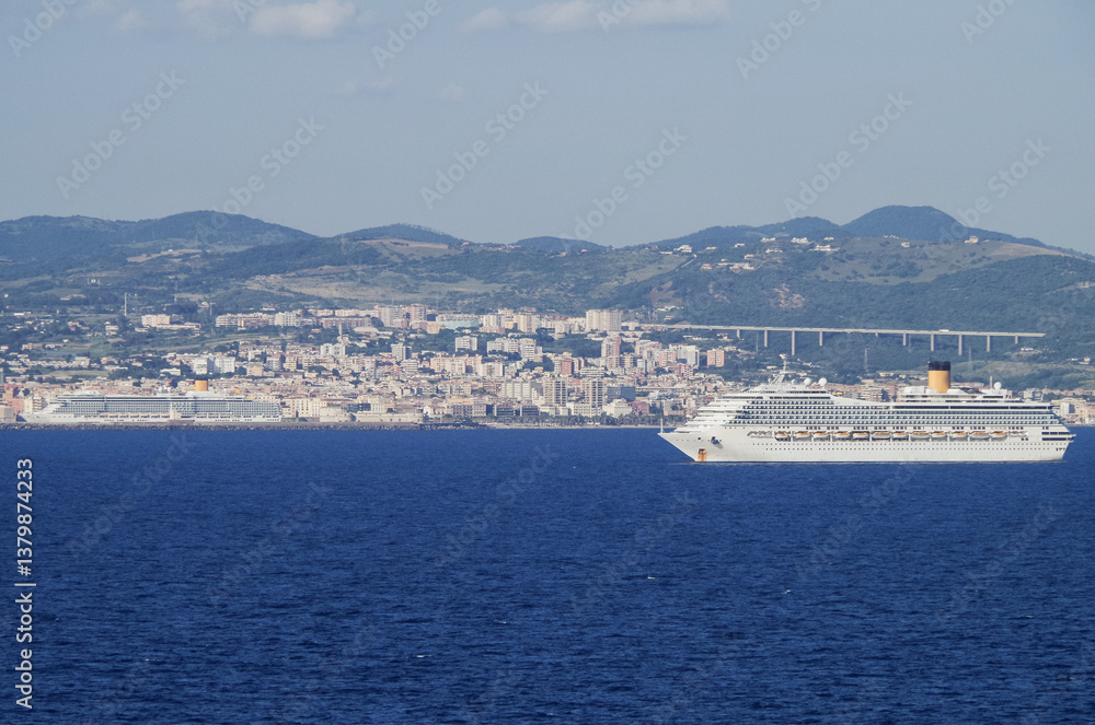 Mega family cruiseship cruise ship liner Fortuna anchored offshore of Civitavecchia Rome, Italy before reactived after Covid pandemic with other vessels in port and coastline