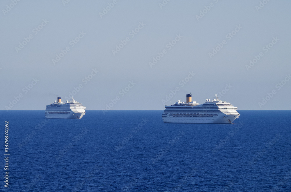 Mega family cruiseship cruise ship liners Favolosa and Fortuna anchored offshore of Civitavecchia Rome, Italy before reactived after Covid pandemic with other vessels in port and coastline