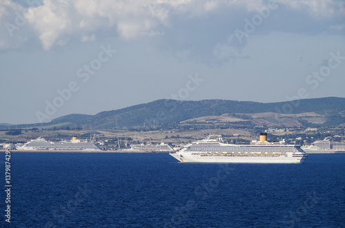 Obraz na płótnie Mega family cruiseship cruise ship liner Fortuna anchored offshore of Civitavecchia Rome, Italy before reactived after Covid pandemic with other vessels in port and coastline w salonie