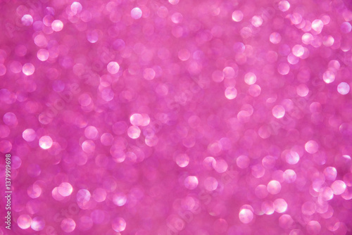 A soft pink bokeh-style background with unfocused light creates an elegant space for text or design elements.