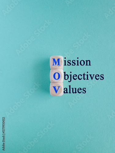 Mission objectives values symbol. On the wooden cubes concept words Mission Objectives Values. Beautiful blue background. Business mission objectives values concept.