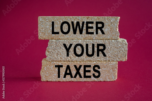Obraz na płótnie Lower your taxes symbol. Concept words Lower your taxes on brick blocks on a beautiful red background. Business tax lower your taxes concept. Copy space. w salonie