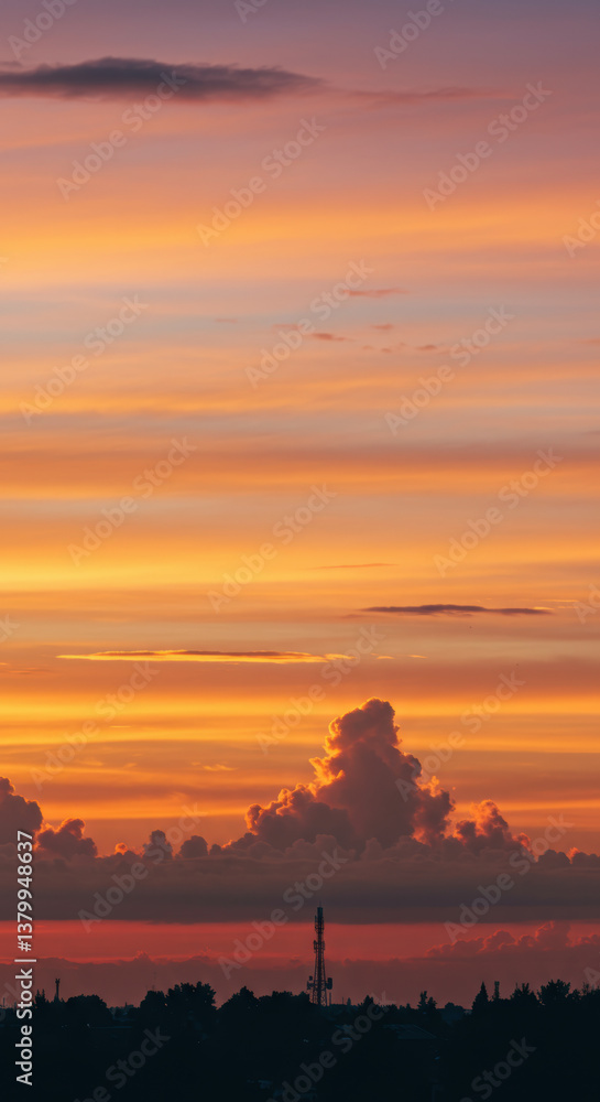 Fototapeta premium The fiery sunset creates a breathtaking display of colors across the expansive sky.