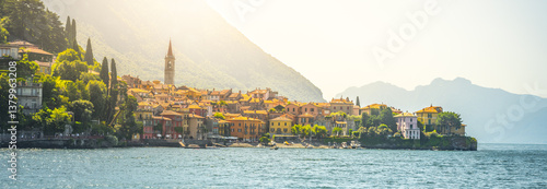 Menaggio sits gracefully along the shores of Lake Como, showcasing its charming architecture and stunning natural surroundings illuminated by warm sunlight, creating a picturesque experience.
