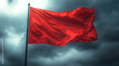 Red flag waving in the wind under a stormy sky