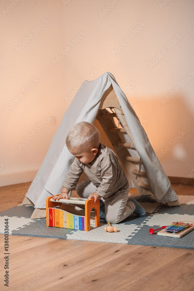 A cheerful child happily plays with a colorful musical toy in a cozy tent, sparking curiosity and creating a delightful experience, while a caring parent watches with love and support