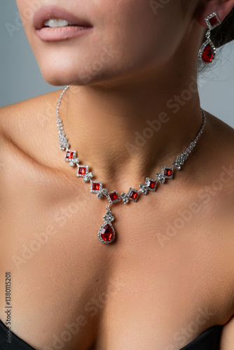 Elegant Necklace with Red Gemstones Displayed on Woman
