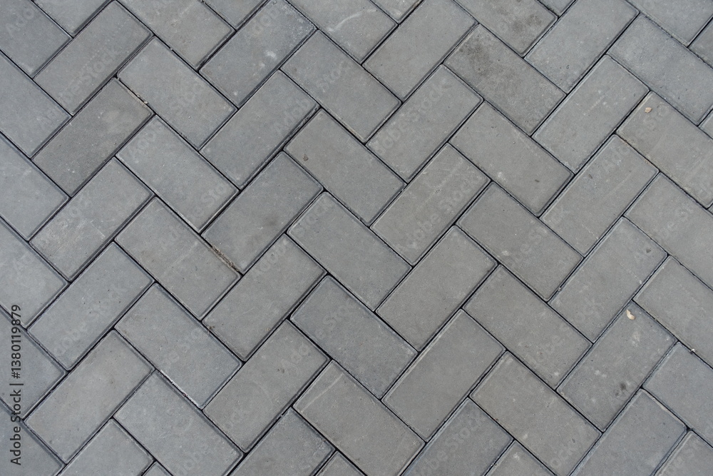Background - grey concrete pavement with single herringbone layout