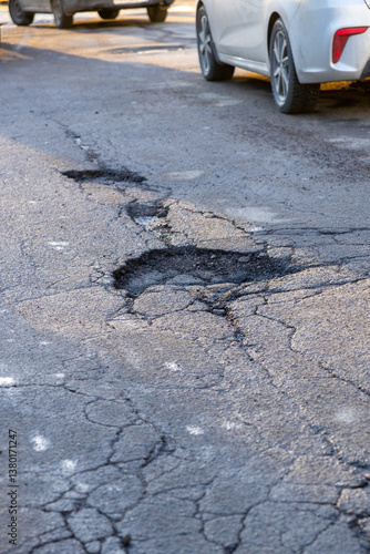 potholes in the road, holes in the asphalt on the roadway or highway. road surface repair work.