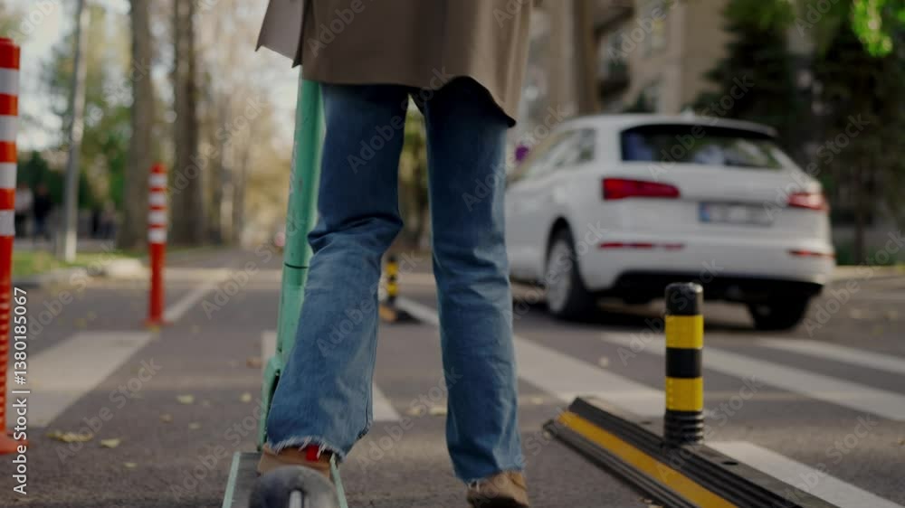 An urban scene featuring a man in jeans walking past a fallen electric scooter on a pedestrian crosswalk in a city, suggesting themes of mobility, safety, and urban transport. An urban scene featuring a man in jeans walking past a fallen electric scooter on a pedestrian crosswalk in a city, suggesting themes of mobility, safety, and urban transport.