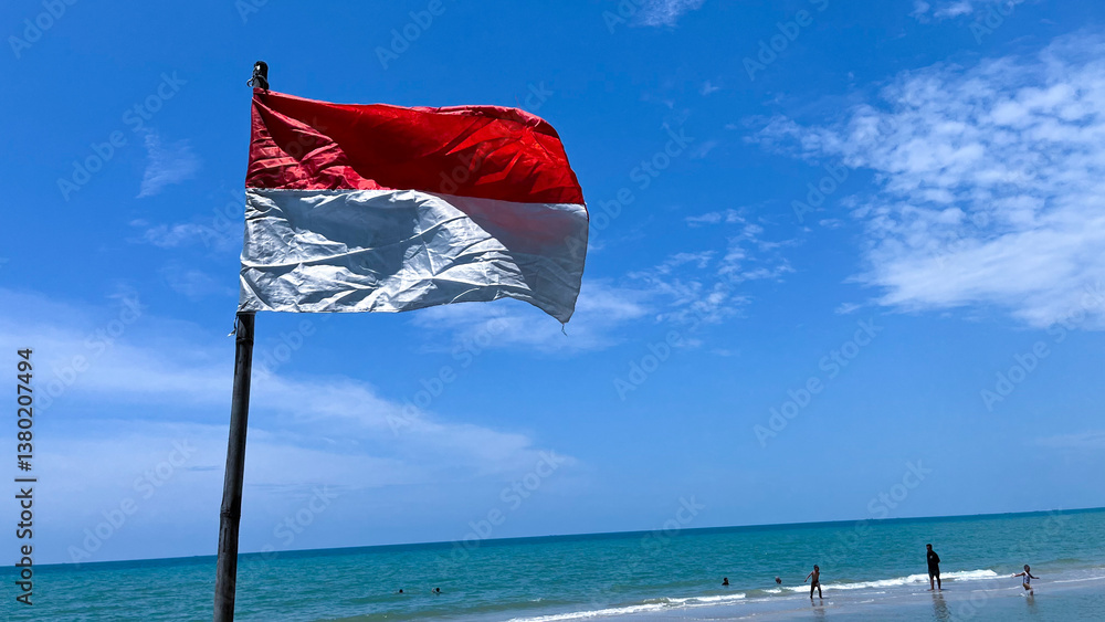 Fototapeta premium The Indonesian flag flutters in the blue sky