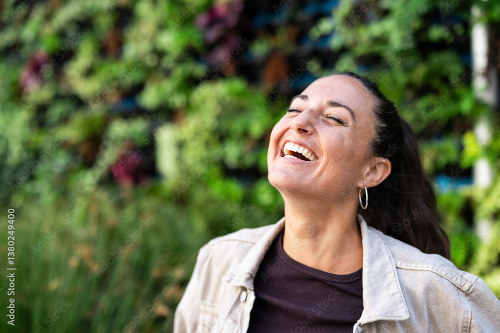 Happy woman smiling outdoors in a city with greenery Happy woman smiling outdoors in a city with greenery