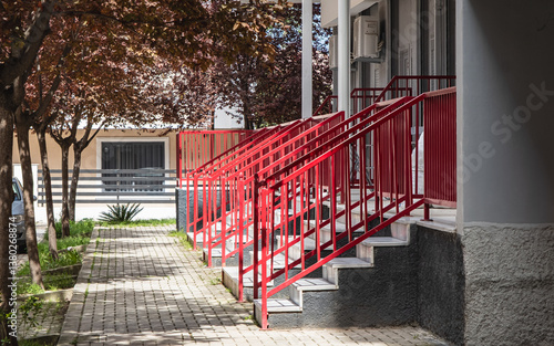 Canvas Print Steel handrail painted red color at stairways of a residential apartment buildin