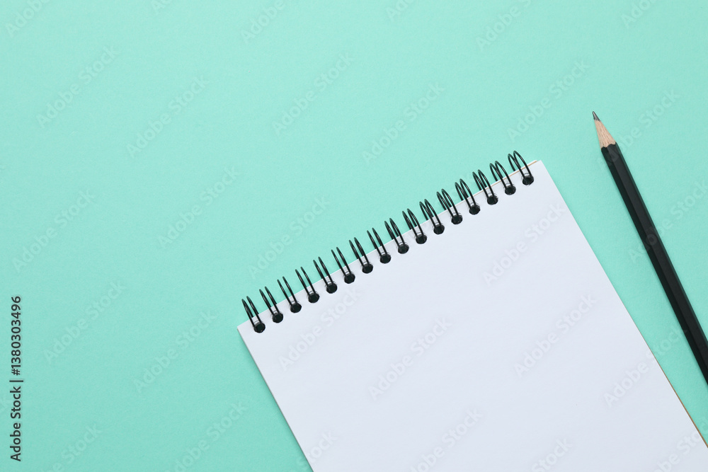 Top view photo of notebook with a pencil on color background with blank space. Business concept Top view photo of notebook with a pencil on color background with blank space. Business concept