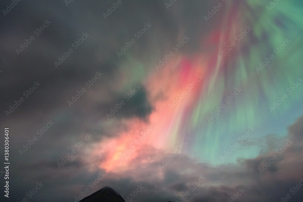 The Northern Lights dance over the Isle of Skye, painting the night sky in vibrant greens and purples. A magical display above Scotland’s rugged landscapes.