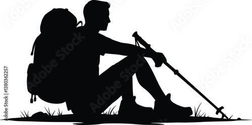 Silhouette of a resting hiker sitting on the ground with a backpack and trekking pole