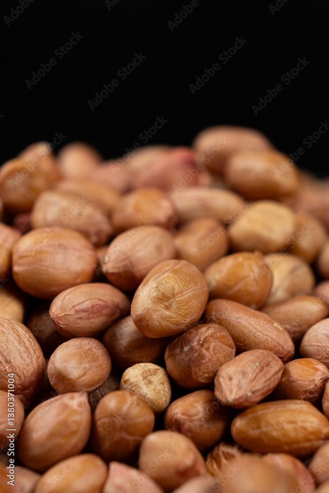 Peanut background, lots of raw peeled brown peanuts close-up. Peanut background, lots of raw peeled brown peanuts close-up.