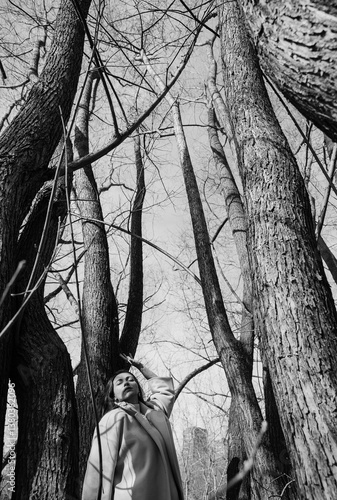 A young woman among the trees