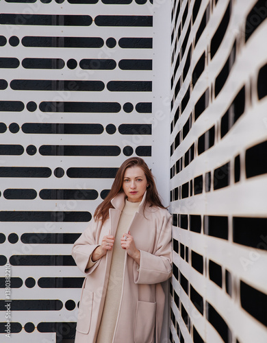 A young woman on the background of a wall
