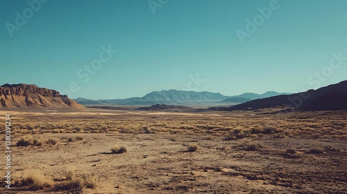 wide shot of a vast desert landscape with mountains in the background under a clear blue sky for scene is serene untouched concept.