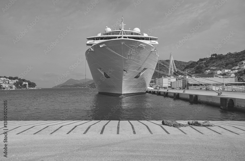 Classic cruiseship cruise ship liner Neo Classica docked in Dubrovnik, Croatia with island archipelago and coast line beautiful nature landscape scenery and city skyline during Adria cruising