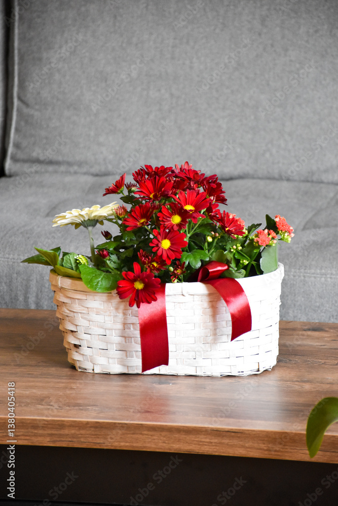 White Wicker Basket as a Planter with Red and White Flowers White Wicker Basket as a Planter with Red and White Flowers