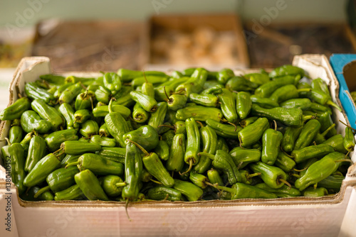selling green peppers at a neighborhood market