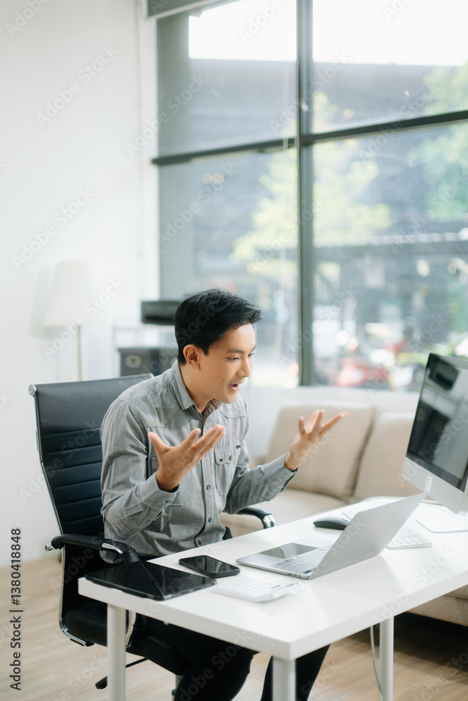 Young businessman working with working notepad, tablet and laptop documents talking Young businessman working with working notepad, tablet and laptop documents talking