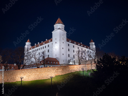 Photography Bratislava Castle illuminated at night, overlooking the city from a hilltop in the capital of Slovakia, showcasing historic architecture and scenic beauty