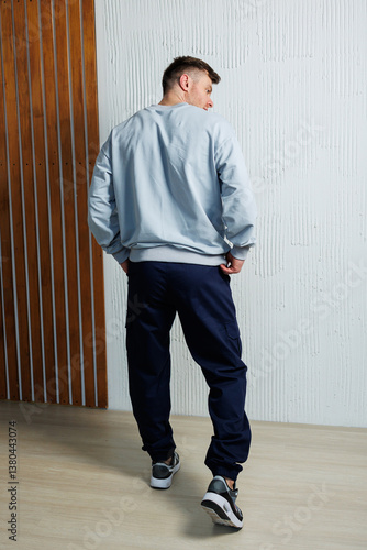 Obraz na płótnie Explore a stylish casual wear collection for men featuring a contemporary athletic look with a comfy gray sweatshirt and sleek navy jogger pants, perfect for active lifestyles and staying fashionable w salonie