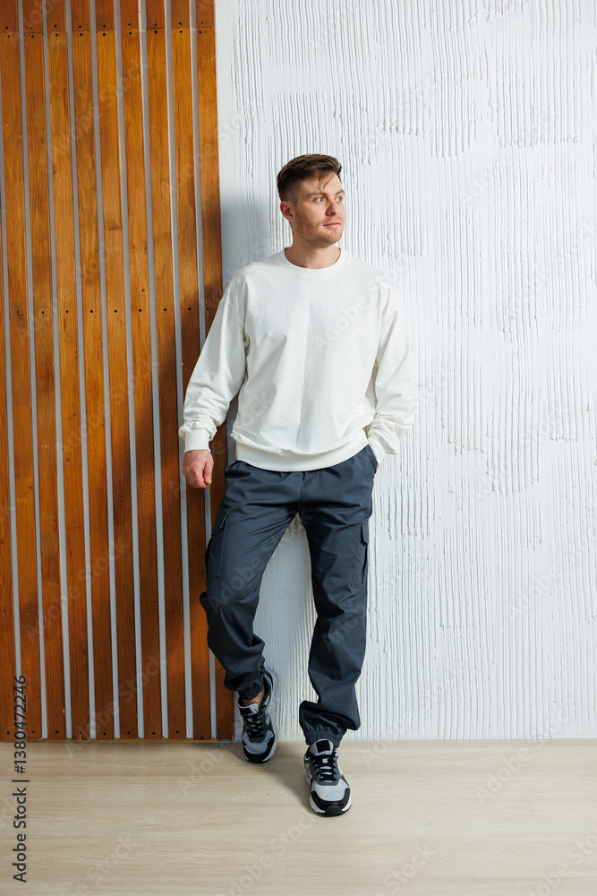 Casual Modern Fashion A Young Man Happily Posing and Smiling in Trendy Attire Against an Elegant and Stylish Background, Radiating Confidence, Charm, and a Sense of Personal Style