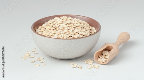 Bowl filled with rolled oats, wooden scoop beside, showcasing wh