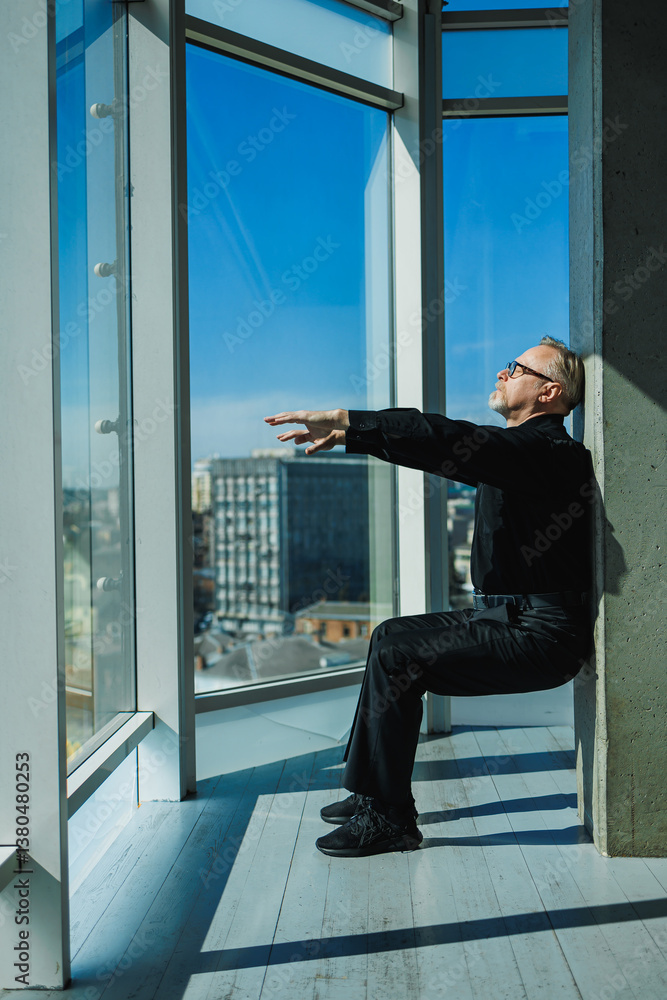 A focused individual meditates by a window, enjoying a captivating city skyline in a serene modern space that enhances mindfulness, promoting reflection, inner peace, and personal growth