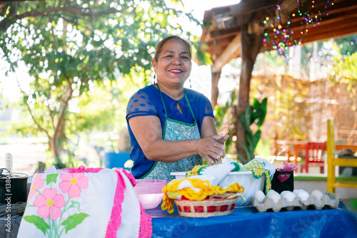 Latin american woman preparing traditional food in outdoor kitchen