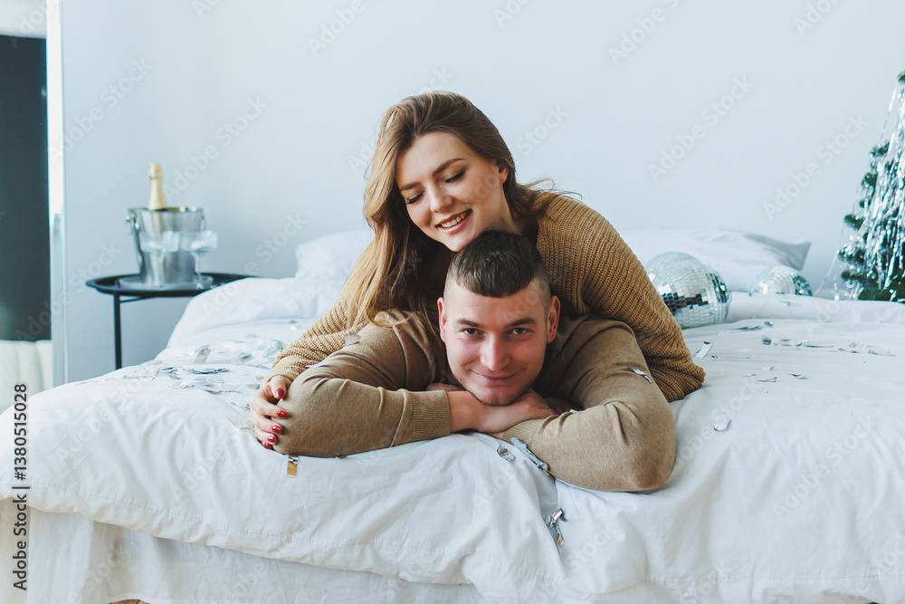 A Joyful Couple Celebrating Their Togetherness in a Cozy Bedroom Adorned with Festive Decor and Surrounded by Warm Embraces, Filling the Space with Cheerful Moments of Happiness and Love