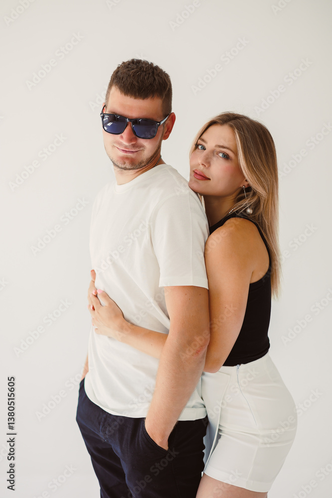 A lively young couple confidently poses against a vibrant background, showcasing their energy, creativity, and joy from their genuinely happy expressions as they enjoy each others company