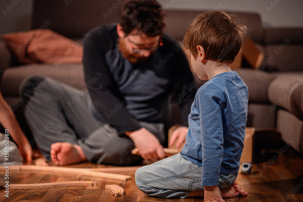 Fototapeta premium Father and Son Building Wooden Train Tracks at Home