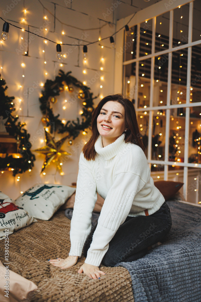 Cute girl in New Year's locations in a cozy living room. Woman at home for the new year.